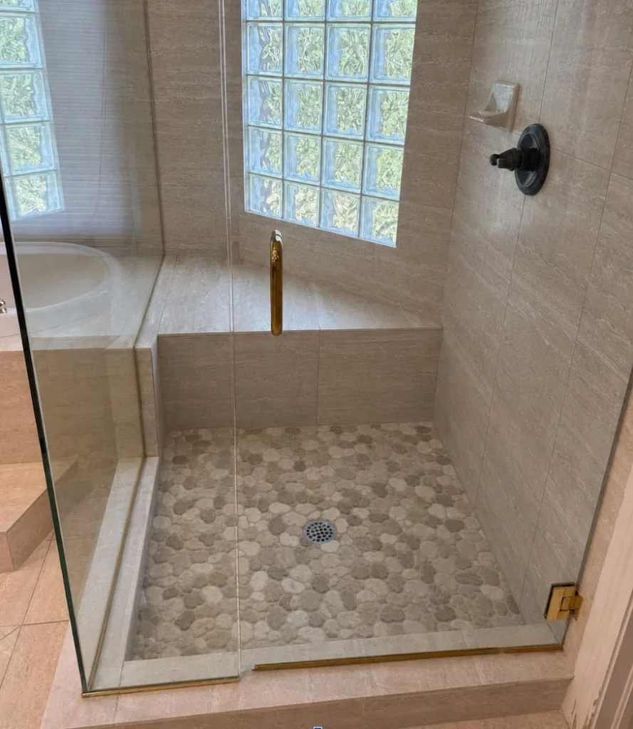 After: Pebble Floor Tile Walk-in Shower Remodel in Arvada, CO